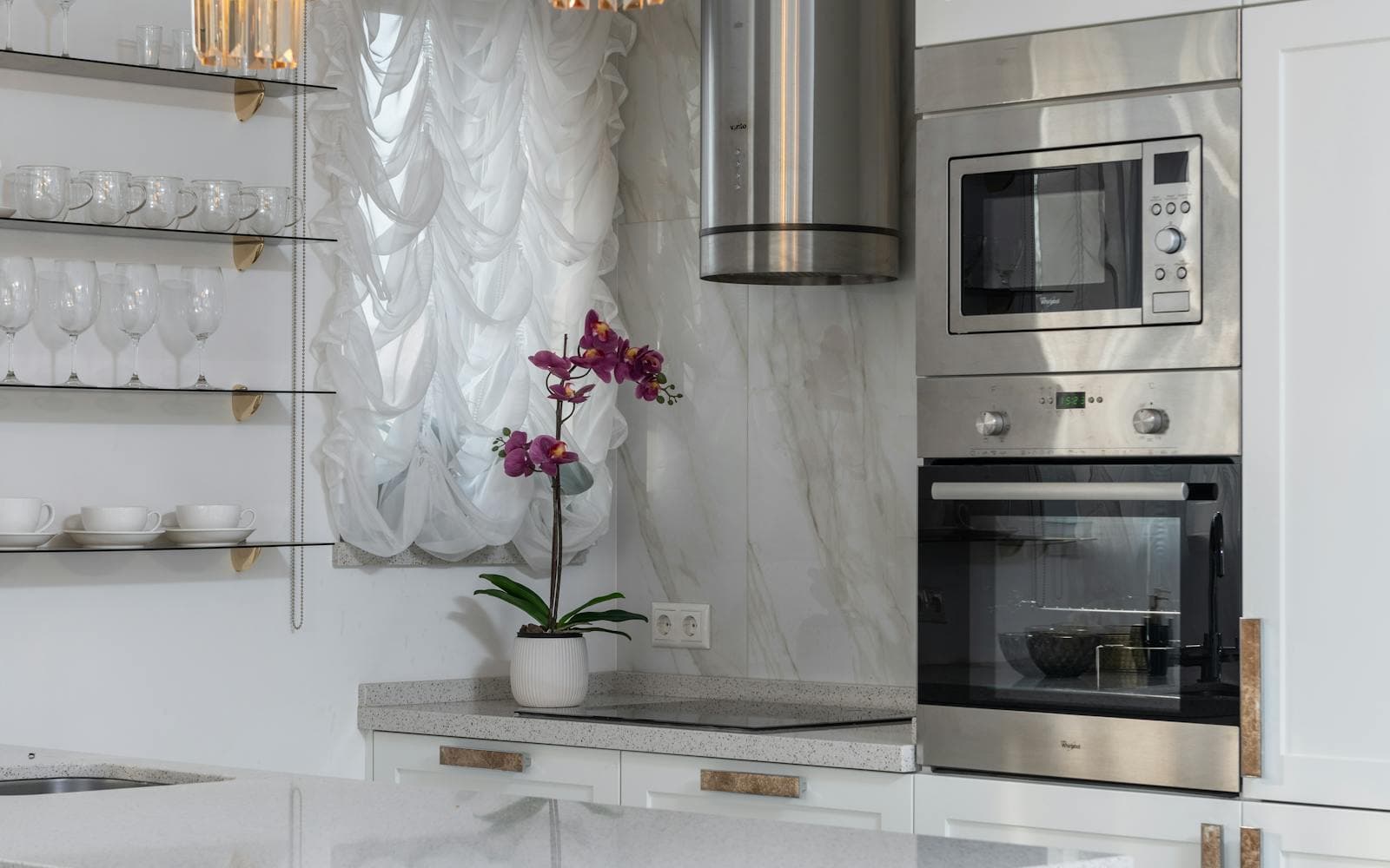 A bright kitchen with small appliances on the bench